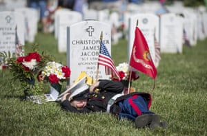 Christian Jacobs, 4, of Hertford, North Carolina, lies on the grave of his father, Christian James Jacob, during Memorial Day celebrations at Arlington National Cemetery.