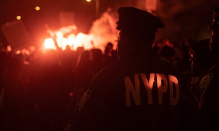 Protesters light flares outside One Police Plaza after NYPD officers arrested students and faculty while clearing the New York University (NYU) “Gaza Solidarity Encampment”.