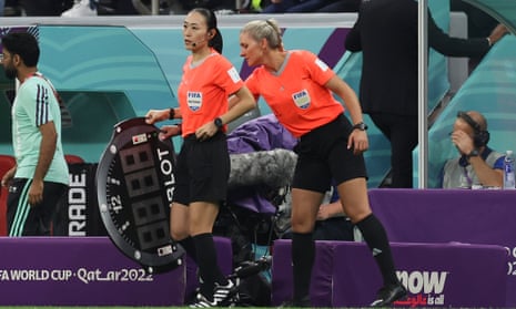 Fourth Official, Yoshimi Yamashita on the touchline.