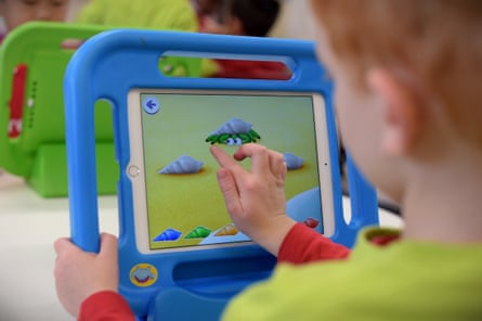 A boy plays on an iPad at an early-learning centre.