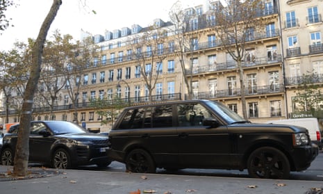 SUVs parked on a road in Paris, France.