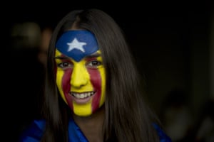 A girl with an estelada flag painted on her face