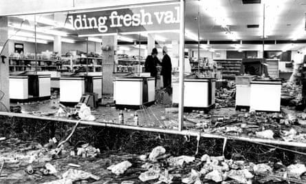 Police officers in a looted supermarket after the riots.