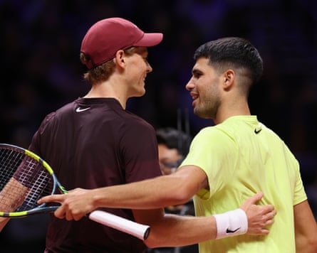 Carlos Alcaraz (right) hugs Jannik Sinner