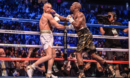 Conor McGregor and Floyd Mayweather in action in 2017.