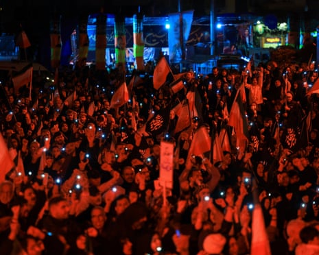 People chant slogans during an anti-US and Israel rally at Enghelab Square in Tehran