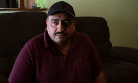 Jose Tovar sits on a dark couch at his home in Amarillo, Texas.