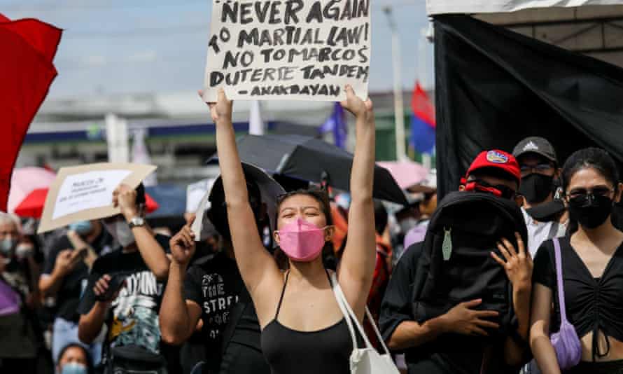 Sign carried by female protester reads ‘Never again to martial law!’