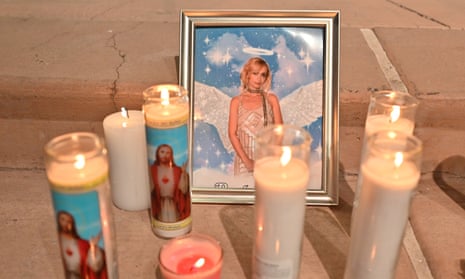 Candles are placed around a photo of cinematographer Halyna Hutchins during a vigil held in her honor at Albuquerque Civic Plaza