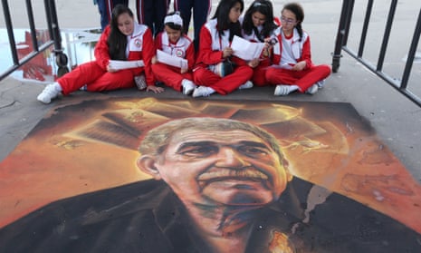 Students sit next to a chalk painting of Colombian novelist Gabriel García Márquez, in Bogota, in 2015.