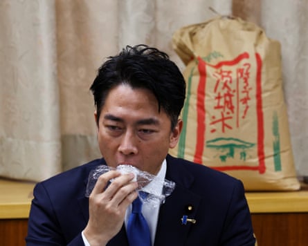 Shinjiro Koizumi eats a rice ball made of stockpiled rice