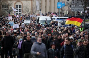 Protestors take part in a march on 20 March demanding an end to the coronavirus restrictions in Kassel, central Germany.