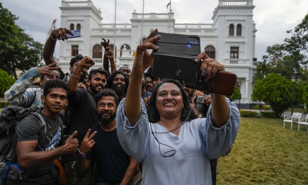Protesters take a selfie as they leave government buildings after military troops reinforced security at the parliament 14 July.