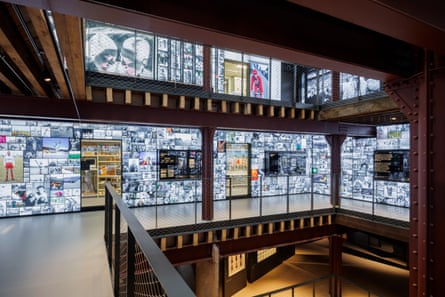 A landing walkway with walls covered in photographic images