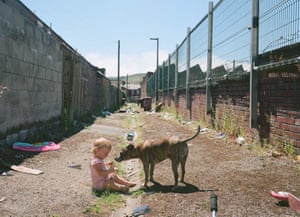 Mark’s daughter Pennie with Sonny the dog, in the back alley behind their home in Darwen, Lancashire (2018)