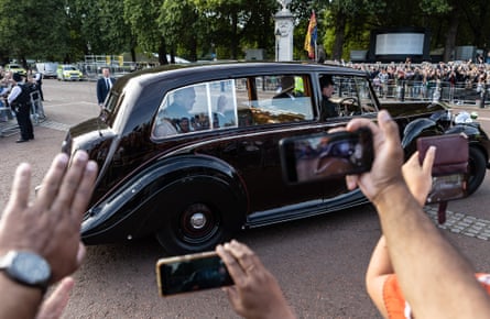 The King waves to the crowds as he leaves Buckingham Palace
