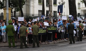 Supporters hold posters including those that read ‘Freedom for Basam Nguyen Huu Vinh’ and ‘Nguyen Huu Vinh is innocent’ during a protest held in front of the People’s Court in Hanoi.