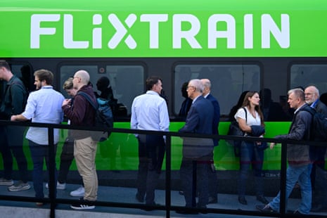 Visitors stand in front of a Flixtrain train at the InnoTrans International Trade Fair for Transport Technology on 22 September in Berlin.