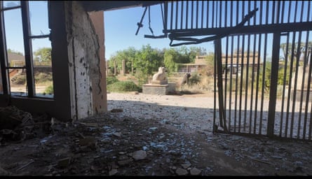 A mangled gate with debris scattered across the ground