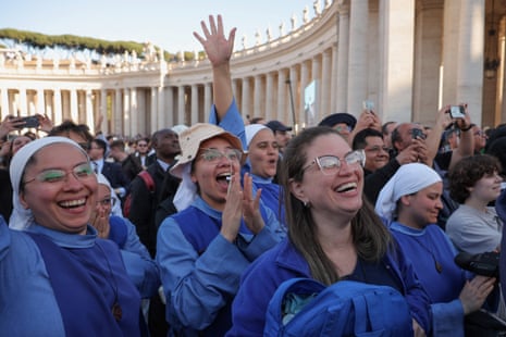 Nuns react to white smoke from the chimney on the Sistine Chapel, indicating that a new pope has been elected.
