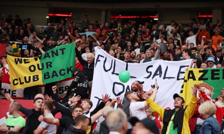 Manchester United fans display banners in protest against the Glazer family’s ownership of the club.