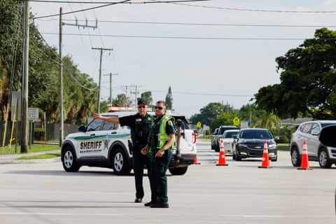 Police officers direct traffic near Trump International Golf Club after the apparent assassination attempt.