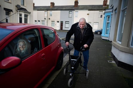 A man uses a walking frame