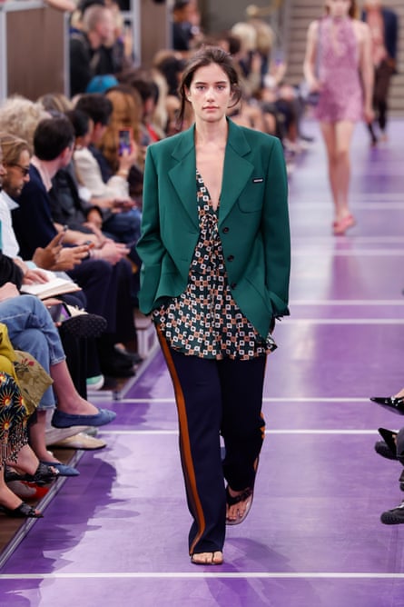 A woman walking down a catwalk.