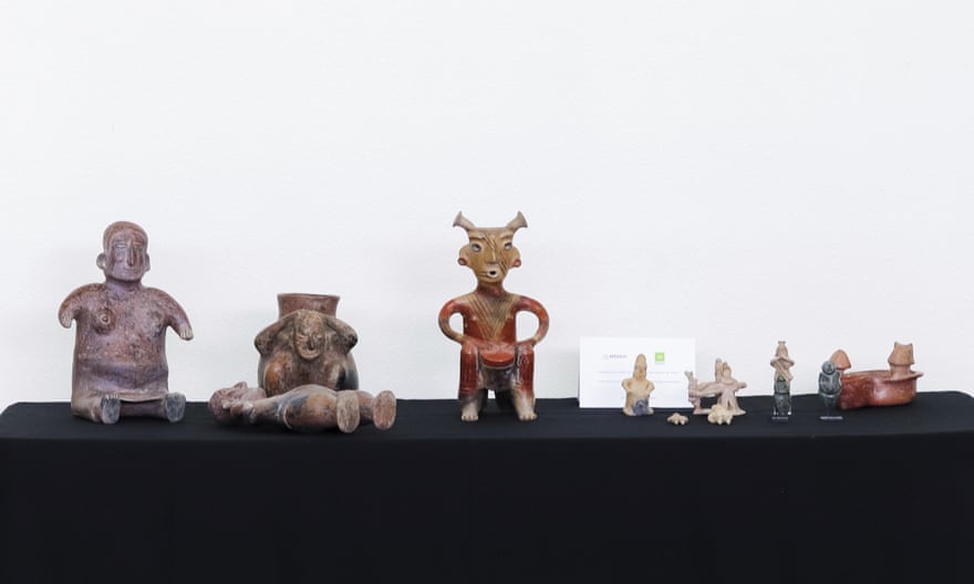 A row of sculptures, several shapes like humans