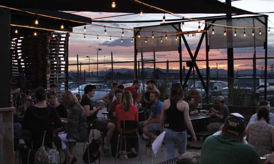 Terrace area, with sunset in the background, at Black Shirt Brewing, Denver.