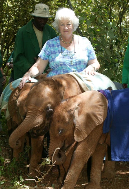 Daphne Sheldrick in 2007 with some orphaned elephants. They are draped in comfort blankets.