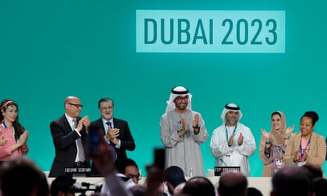 COP28 president Sultan Ahmed Al Jaber (C) applauds among other officials before a plenary session.