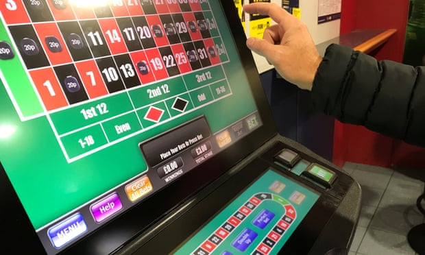 A man gambles on a fixed odds betting terminal.