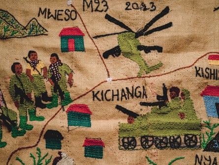 Embroidered artwork of a military tank and helicopter next to a group of armed men.