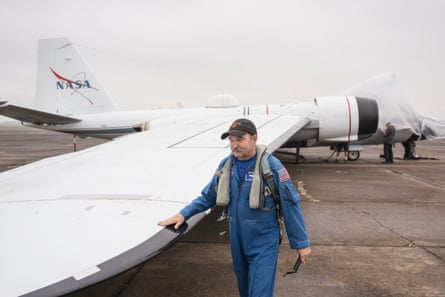 An airman walks next to the wing of a WB-57 aircraft