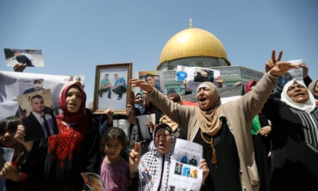 Palestinians take part in a rally in support of Palestinian prisoners held in Israeli jails, in front of the Dome of the Rock.