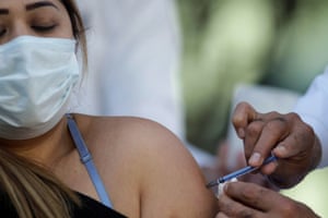 A medical worker receives an injection with a dose of the Pfizer-BioNTech Covid-19 vaccine in Mexico