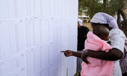 A Kenyan voter checks for her name on lists at a polling station in Nairobi.
