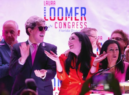 Yiannopoulos and Loomer applaud while smiling on stage, with a ‘Laura Loomer for Congress’ backdrop behind