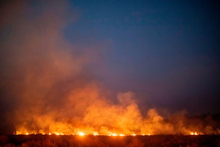 A fire burns out of control after spreading onto a farm along a highway in Nova Santa Helena municipality in northern Mato Grosso State, south in the Amazon basin in Brazil.
