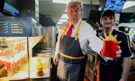 President Donald Trump works behind the counter during a visit to McDonald's