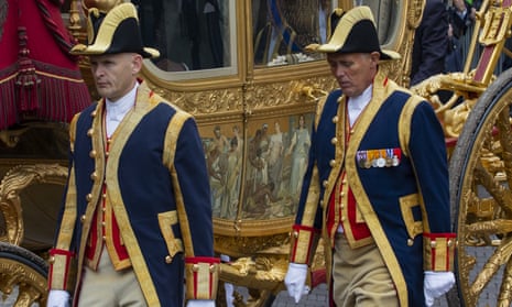 Footmen walk alongside the golden carriage in 2013. The last time the carriage was used was in 2015. 