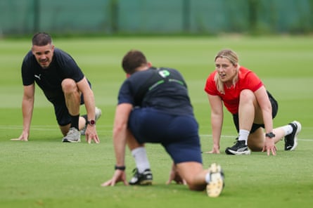 Senior sports scientists Vicky Smith leads the officials in stretching exercises.