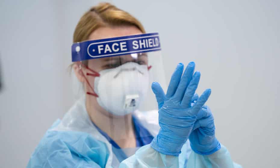 A member of staff receives training on how to put on and remove PPE at the Nightingale Hospital North West in Manchester.