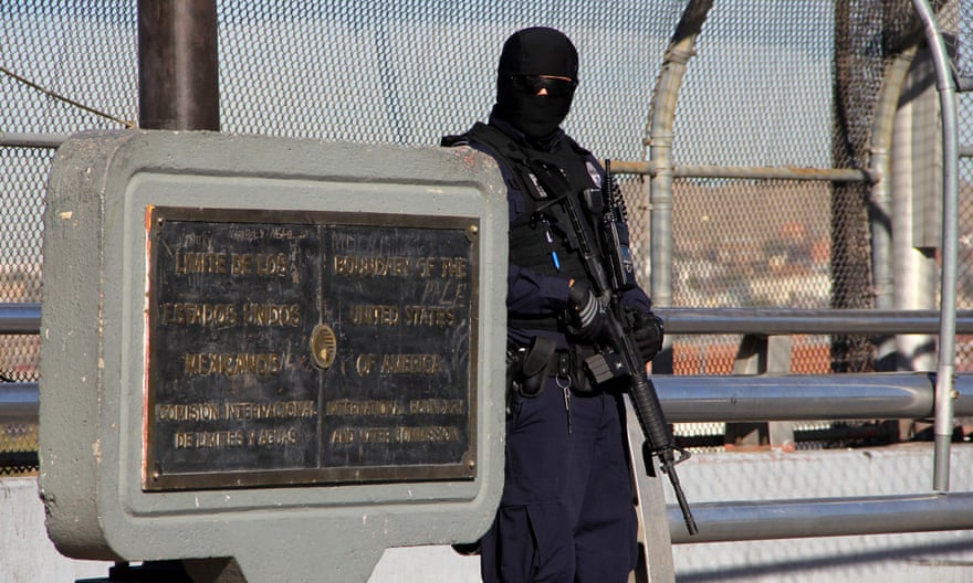 A US customs and border patrol agent on the US-Mexico international bridge.