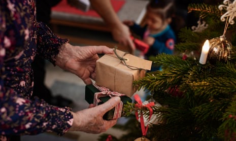 Woman's hands holding Christmas presentsXmas presents under the tree.