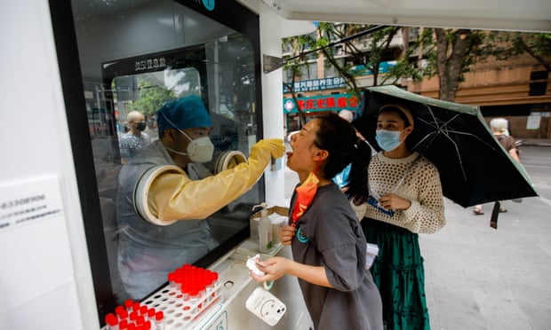 A woman being tested for Covid in Chongqing. New cases in Shenzhen and Dalian have prompted lockdown for millions.