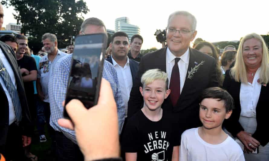 Prime Minister Scott Morrison mingles with members of the public after the Anzac Dawn Service at the Darwin Cenotaph on Day 15 of the 2022 federal election campaign, in Darwin, in the seat of Solomon. Monday, April 25, 2022. (AAP Image/Mick Tsikas)