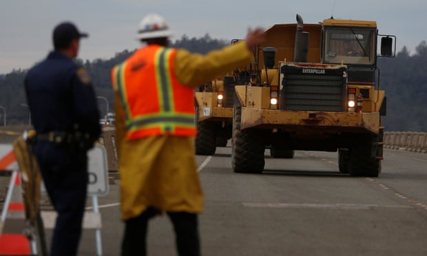 Trucks that hauled rocks drive off the Lake Oroville dam after an evacuation order was lifted for communities downstream. Photograph: Jim Urquhart/Reuters Trucks that hauled rocks drive off the Lake Oroville dam after an evacuation order was lifted for communities downstream. Photograph: Jim Urquhart/Reuters