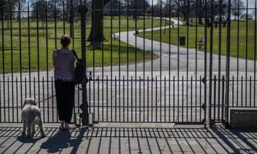 A woman and dog at the gates of Brockwell Park